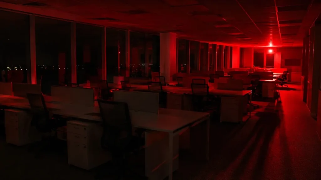 Oracle Cut 21,000 Jobs This Year — and Said AI Will Keep Cutting More Oracle AI layoffs 2026 — empty corporate office with red emergency lighting representing 21000 job cuts